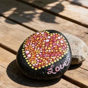 Hand crafted painted heart rock Love black stone dotted yellow pink red orange